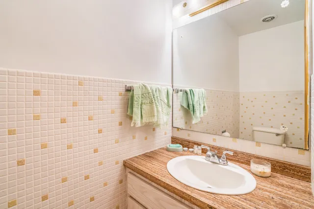 a bathroom with a sink a large mirror and a shower