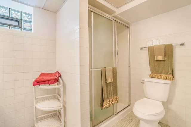 a bathroom with a toilet and a shower