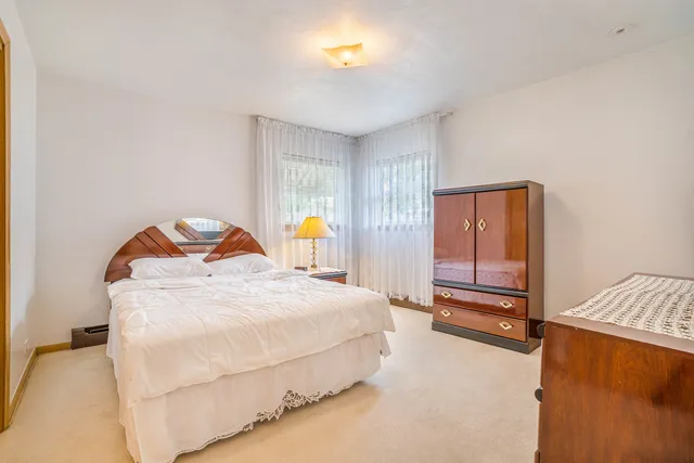 a bedroom with a bed and dresser