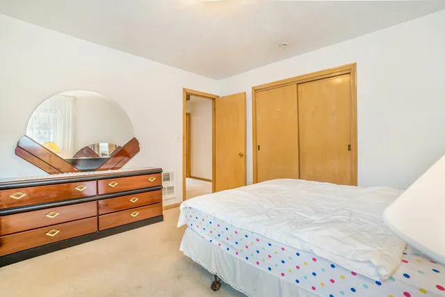 a bedroom with a bed and a dresser