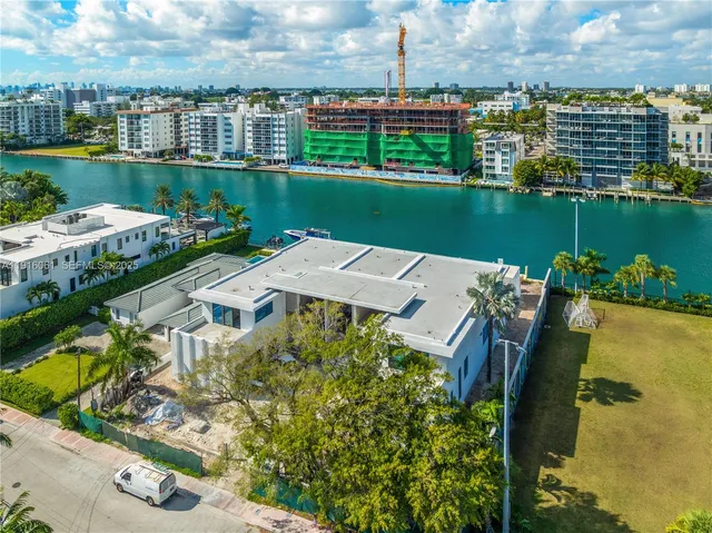 an aerial view of a house with a garden and lake view