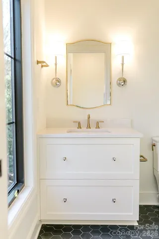 a view of a white house with a yard patio and fire pit