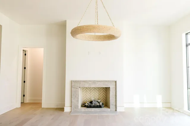 a living room with furniture a fireplace and a large mirror