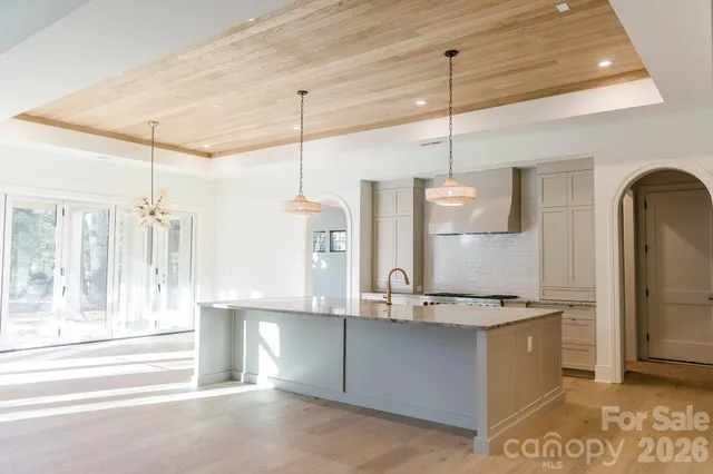 a view of a kitchen with a sink and a chandelier