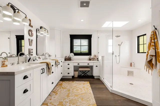 an aerial view of a house with a garden and lake view