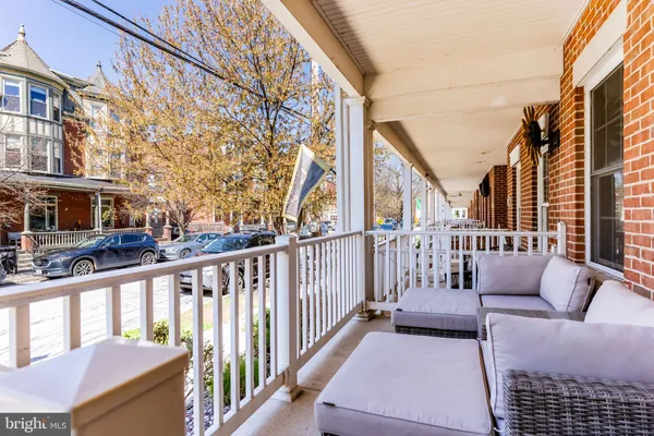 a view of a balcony with couches and a fire pit