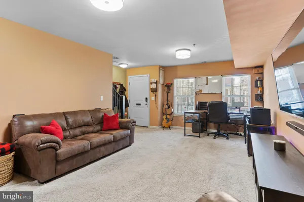 a living room with furniture and large windows