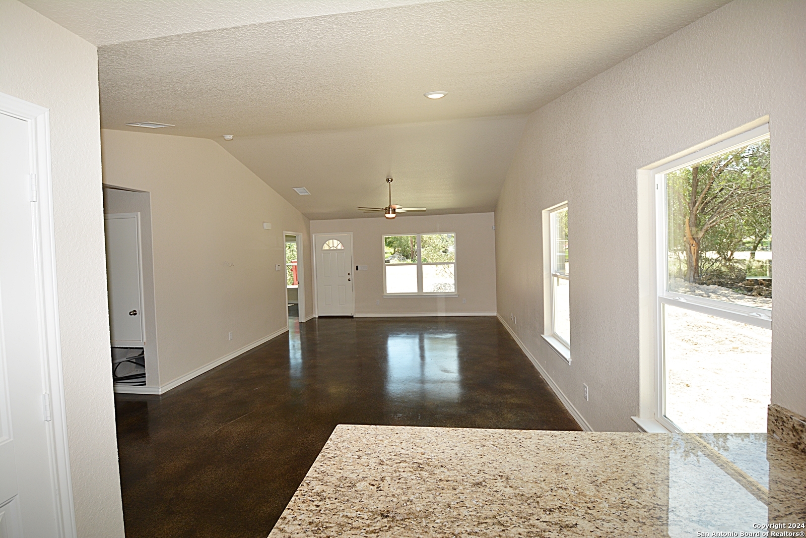 641 Turkey Canyon Drive Spring Branch, TX 78070 - Photo 4 of 11 wooden floor in an empty room with a window