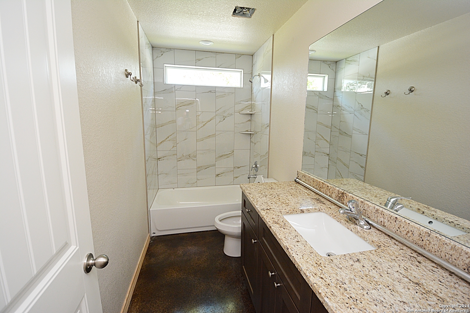 641 Turkey Canyon Drive Spring Branch, TX 78070 - Photo 8 of 11 a bathroom with a granite countertop sink a toilet a mirror and shower