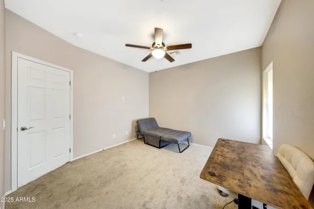 a living room with furniture and a ceiling fan