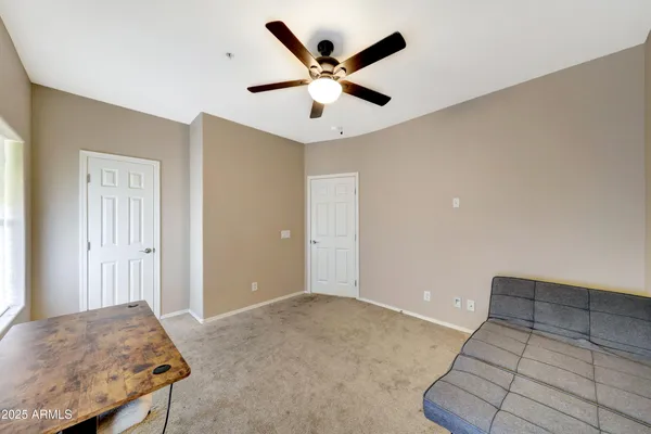 a living room with furniture and ceiling fan