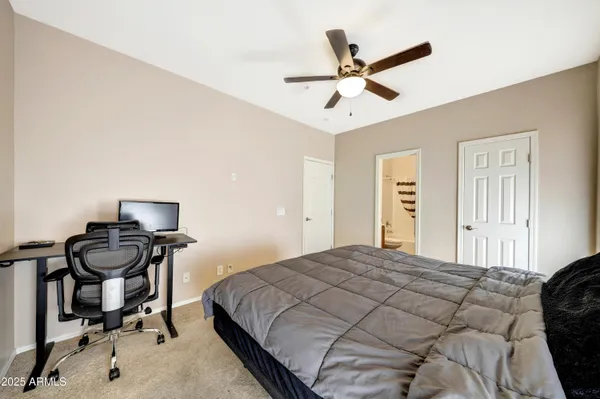 a bedroom with a bed and a desk