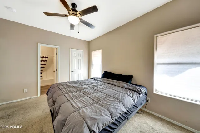 a bedroom with a bed and a desk