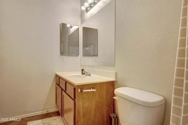 a bathroom with a sink a toilet a mirror and vanity