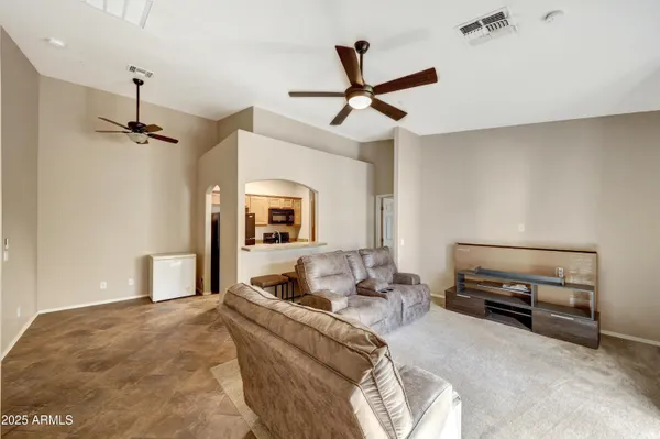 a bedroom with a bed and a ceiling fan