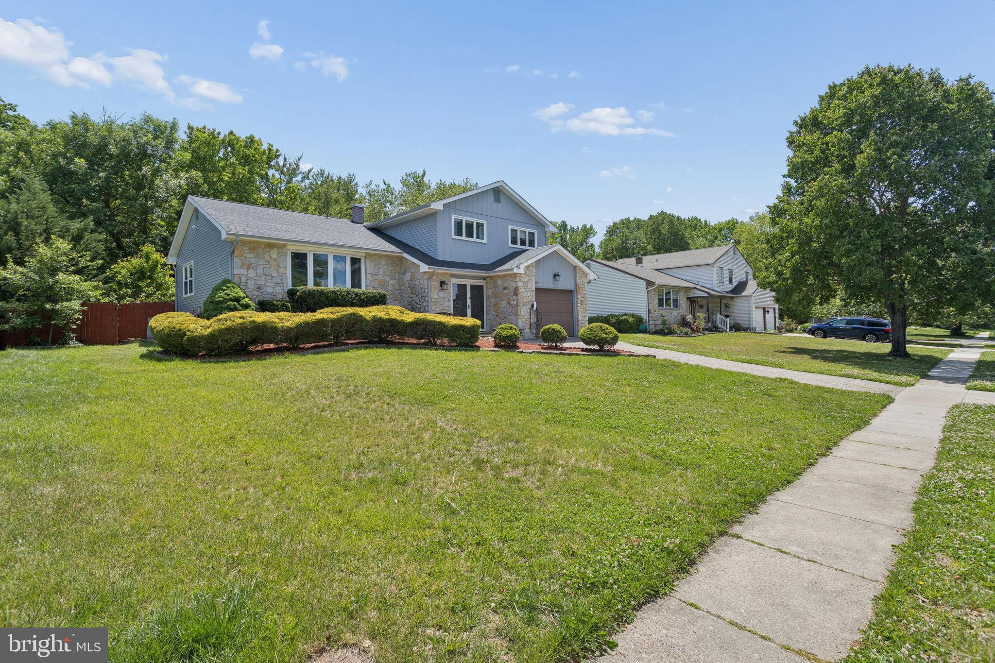252 Sandringham Road Cherry Hill, NJ 08003 - Photo 2 of 31 a front view of a house with a yard and garage
