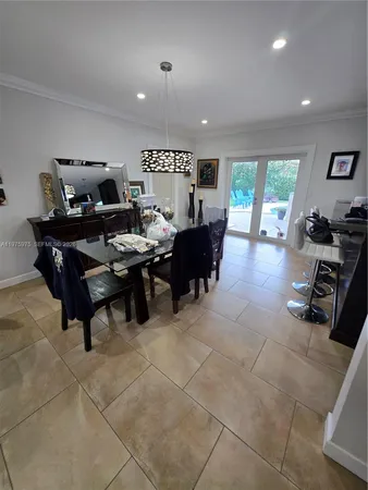 a living room with furniture a large window and a table