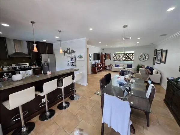 a large kitchen with a table and chairs