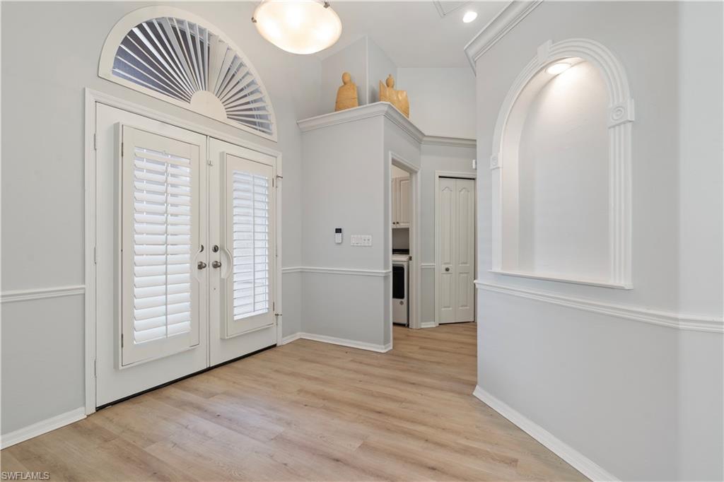 20751 Rivers Ford Estero, FL 33928 - Photo 17 of 36 Entryway with french doors, light wood-type flooring, and washer / clothes dryer