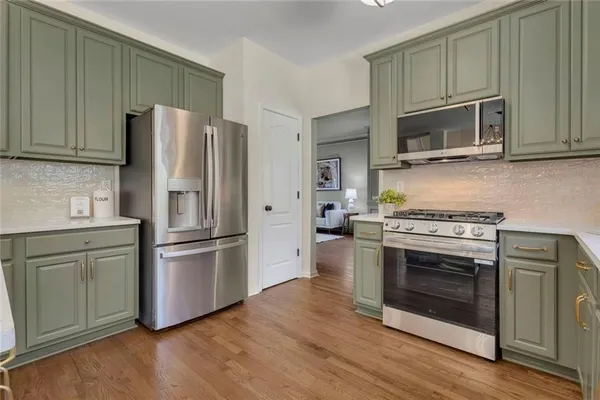 a kitchen with stainless steel appliances and wooden cabinets