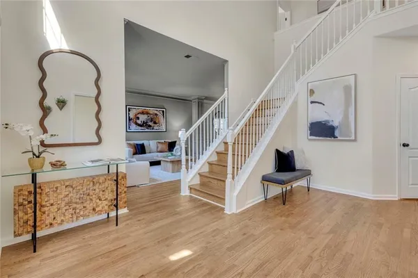 a view of entryway and hall with wooden floor