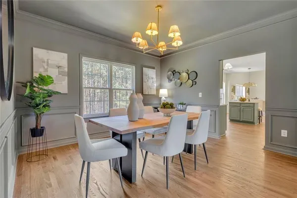 a view of a dining room with furniture window and wooden floor