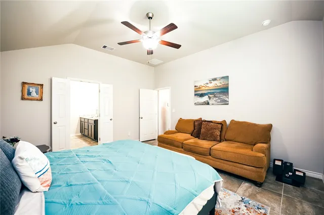 a bedroom with a bed couch and window