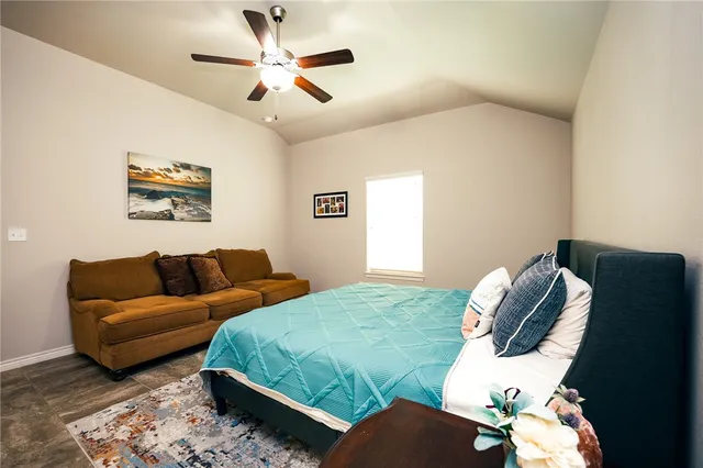 a bedroom with bed and a couch