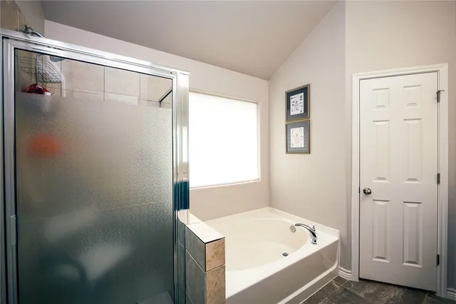 a bathroom with a tub a sink and a shower