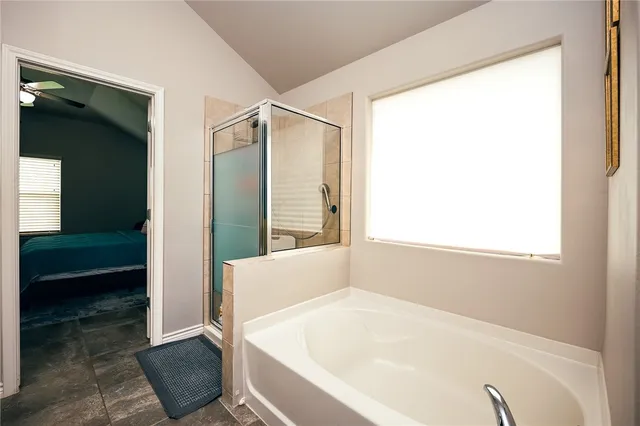 a bathroom with a bathtub and a shower