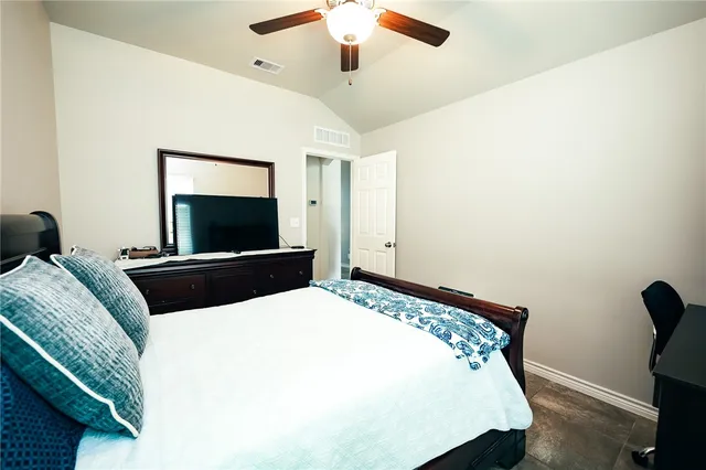 a bedroom with a bed and a flat screen tv