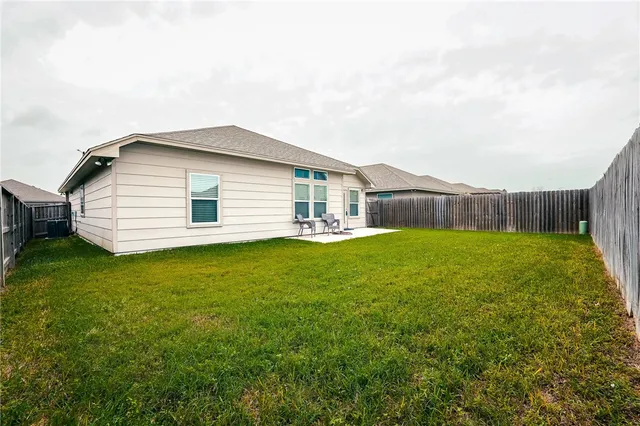 a front view of house with backyard and garden