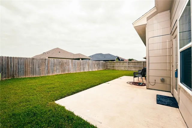 a view of a backyard with a garden and seating area