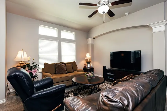 a living room with furniture and a flat screen tv