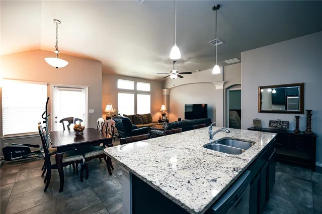 a large kitchen with a table and chairs