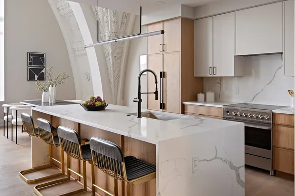a kitchen with stainless steel appliances a sink a stove and cabinets