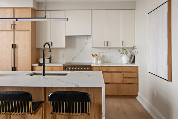 a kitchen with stainless steel appliances granite countertop a sink and a refrigerator