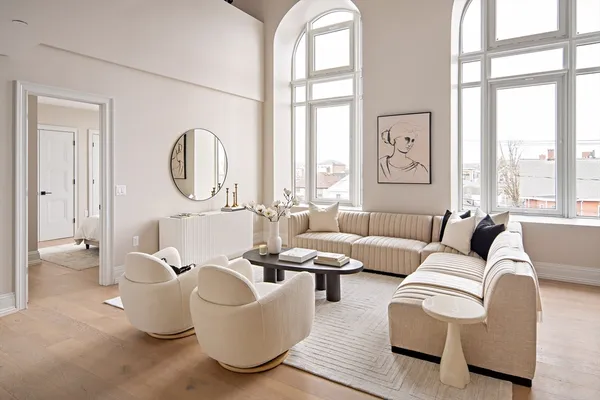 a living room with furniture a large window and a large mirror