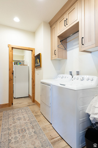 382 Ridgeview Street, Unit 8 & 9 Brian Head, UT 84719 - Photo 22 of 52 Laundry area with light wood-finish cabinetry featuring black hardware and an integrated hanging rod