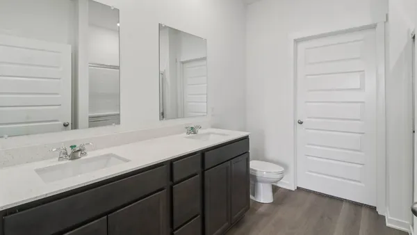 a bathroom with a sink toilet and a mirror