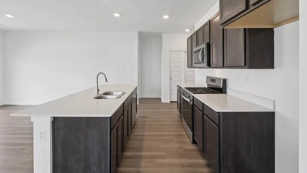 a kitchen with stainless steel appliances kitchen island a sink stove and cabinets
