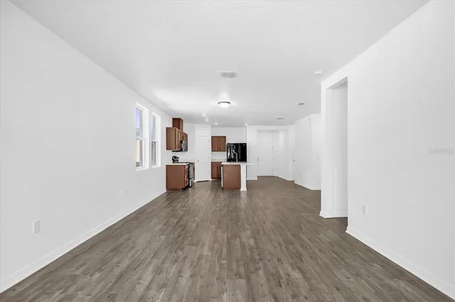 a view of a living room with wooden floor