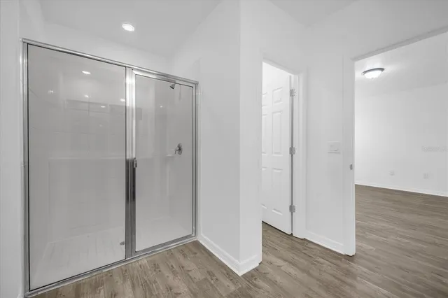 a bathroom with a glass shower door