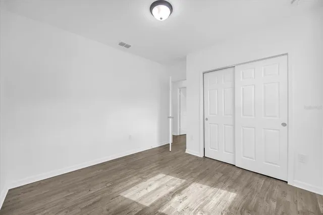 a view of an empty room and wooden floor