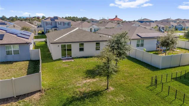 a front view of house with yard and mountain