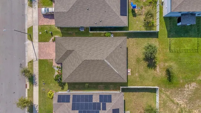 an aerial view of a house with a yard