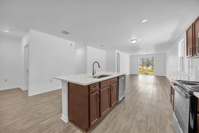 a view of a kitchen counter space a sink and wooden floor