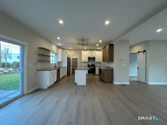 a kitchen with stainless steel appliances a refrigerator and a stove top oven