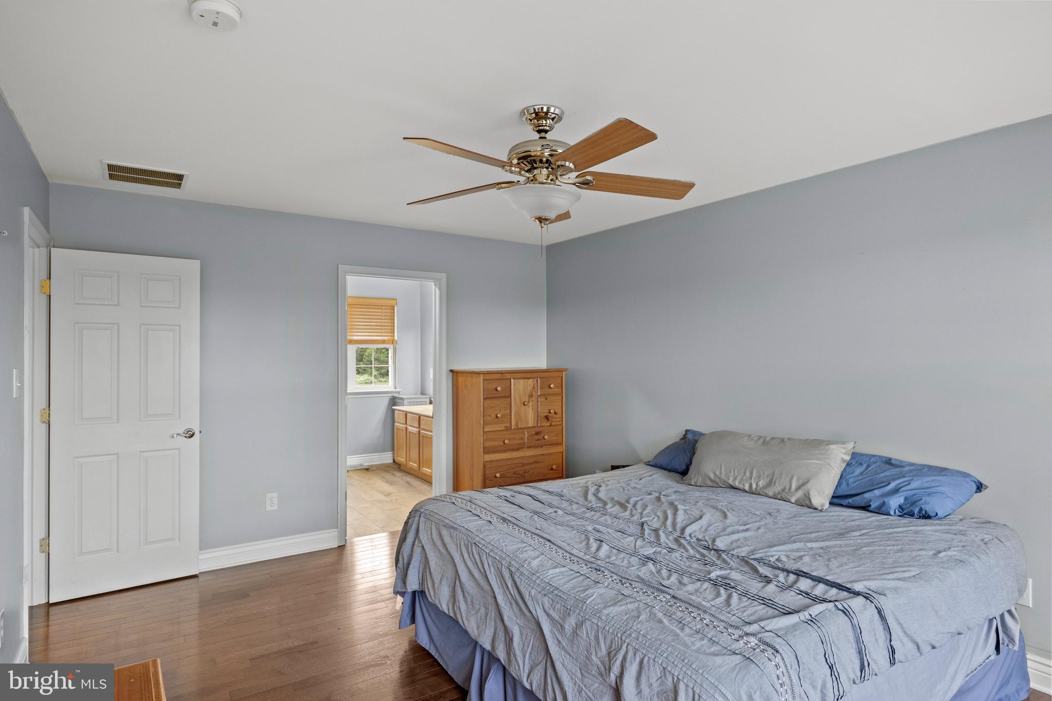545 Lawrence Corner Road Pittsgrove, NJ 08318 - Photo 23 of 43 a bedroom with a bed and a chandelier