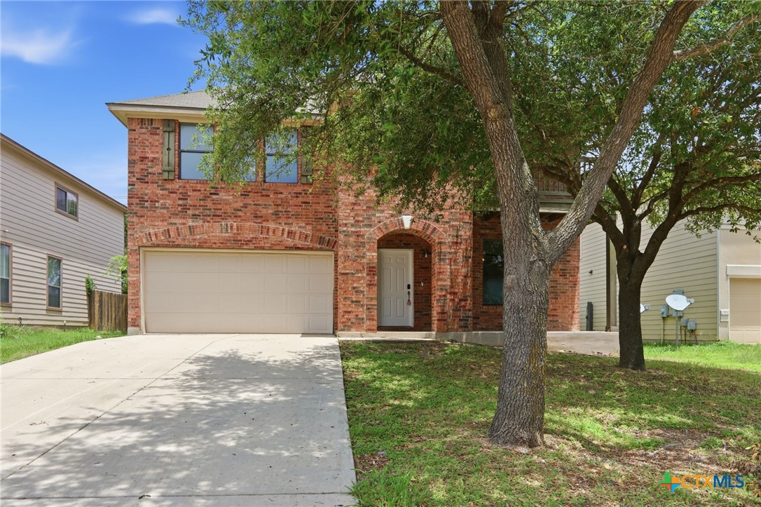 8716 Starview Street Temple, TX 76502 - Photo 1 of 36 Welcoming front elevation highlighting the classic brick facade, wide driveway, and a large mature tree in the front yard.